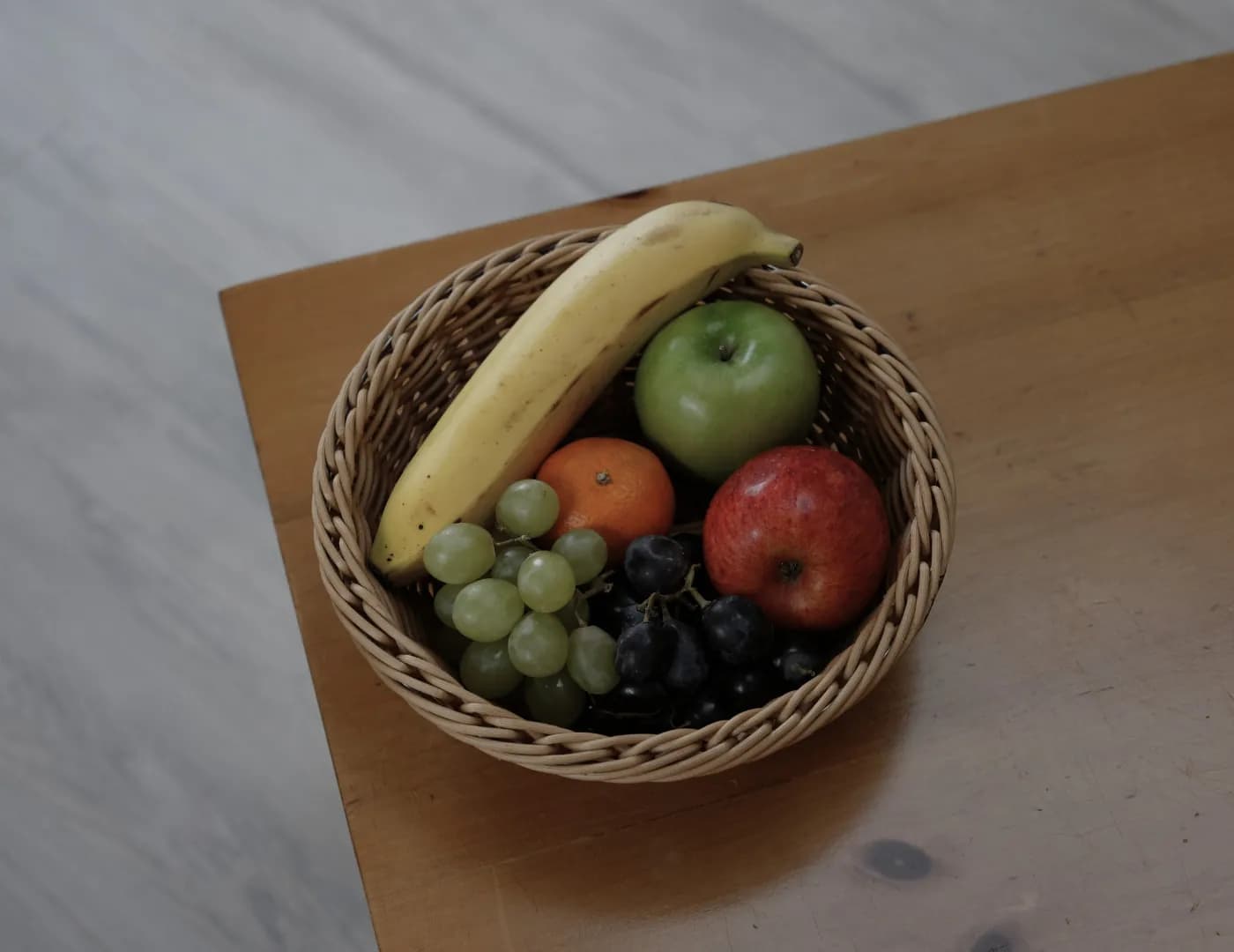 A basket of fruit left on a bare office table
